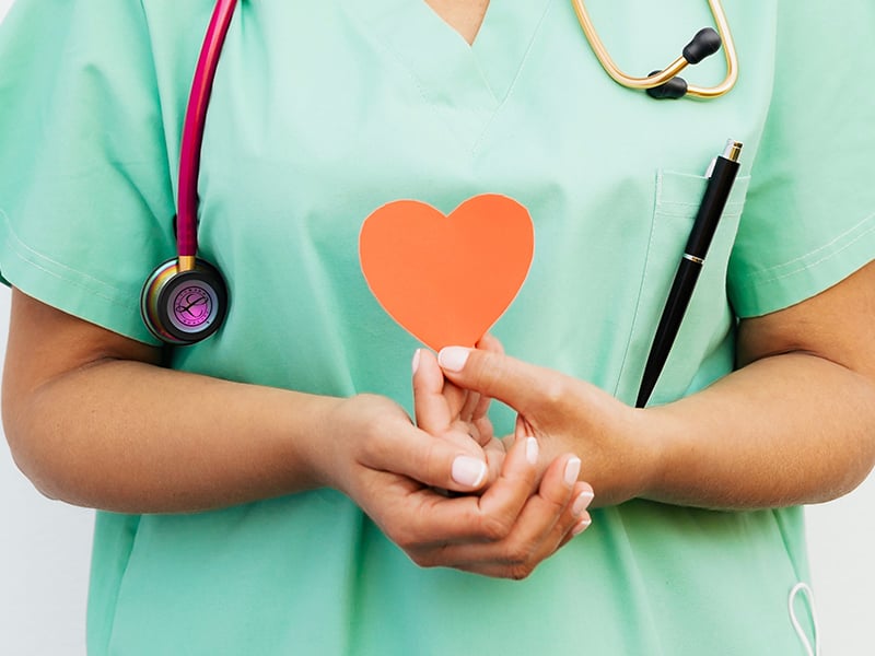 Clinician holding a paper heart